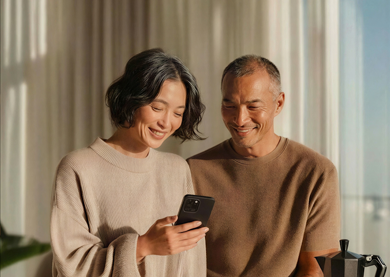 Couple looking at their phone and smiling