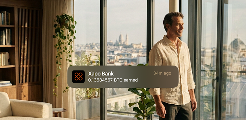 Man looking at the city out his window, getting a notification from Xapo Bank that he earned 0.13684567 BTC.