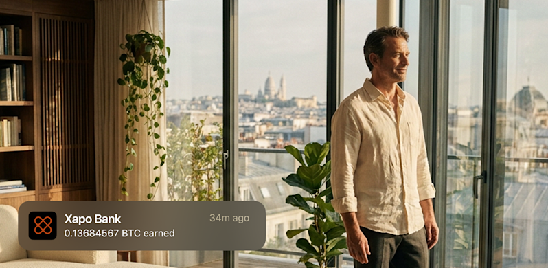 Man looking at the city out his window, getting a notification from Xapo Bank that he earned 0.13684567 BTC.