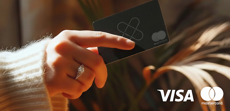 A consumer holding a black premium credit card to make a secure online payment. The image features official Visa and Mastercard merchant logos, emphasizing safe e-commerce transactions, digital banking choices, and global payment processing solutions.